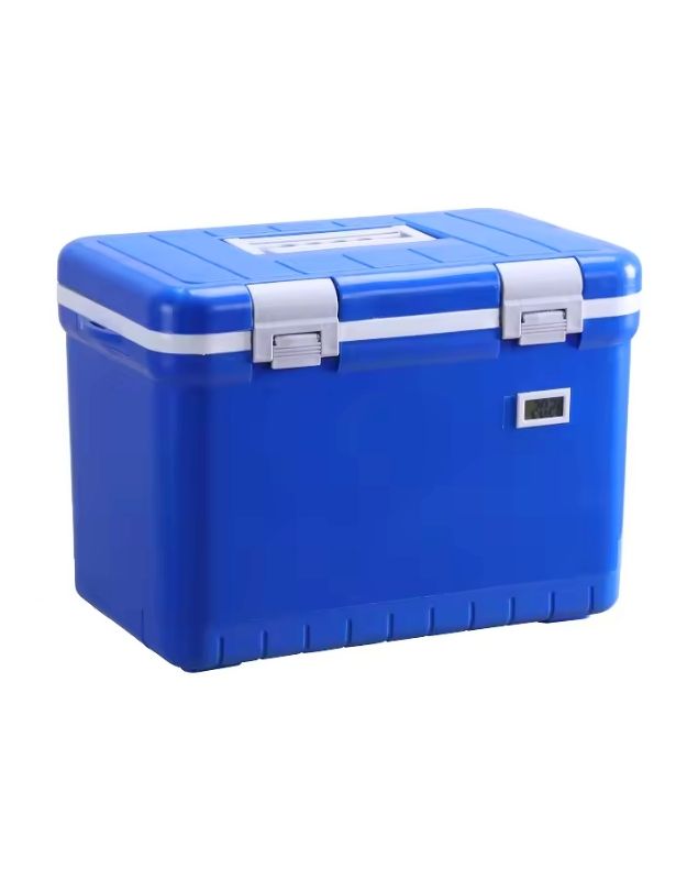 A blue insulated plastic cooler box with grey handles and a thermometer display on the front. Blue insulated cooler box with secure lock and digital temperature display.